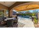 Inviting patio with retractable awning and view of the pool and landscaped backyard at 8923 E Mountain Spring Rd, Scottsdale, AZ 85255