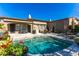 Backyard featuring a sparkling pool, lounge chairs, and lush landscaping at 8923 E Mountain Spring Rd, Scottsdale, AZ 85255