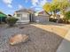 Gray house with a two-car garage and a large rock in the front yard at 9023 W Hubbell St, Phoenix, AZ 85037