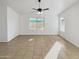 Sunlit living room featuring tile floors and fan at 9023 W Hubbell St, Phoenix, AZ 85037