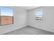 Bright bedroom featuring carpet floors and two windows at 9054 S 169Th Dr, Goodyear, AZ 85338