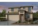 Two-story house with beige siding, brown brick accents, and a two-car garage at 9054 S 169Th Dr, Goodyear, AZ 85338