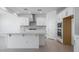 Bright kitchen featuring white cabinets, stainless steel appliances, and a large island at 9054 S 169Th Dr, Goodyear, AZ 85338