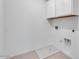 Laundry room featuring storage cabinets and tile flooring at 9054 S 169Th Dr, Goodyear, AZ 85338