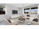 Inviting living room with a comfortable sectional sofa, stylish decor, and plenty of natural light from large windows at 9054 S 169Th Dr, Goodyear, AZ 85338
