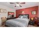 Relaxing bedroom with ceiling fan and striped bedding at 9333 E University Dr # 86, Mesa, AZ 85207