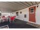 Covered patio with red chairs and table, providing an outdoor dining space at 9333 E University Dr # 86, Mesa, AZ 85207