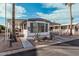 Front view of the manufactured home with carport and landscaping at 9333 E University Dr # 86, Mesa, AZ 85207