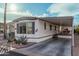 Front view of the manufactured home with carport and landscaping at 9333 E University Dr # 86, Mesa, AZ 85207