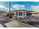 White mobile home with gray roof and covered carport, landscaping, and a paved driveway at 9333 E University Dr # 86, Mesa, AZ 85207