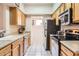 Galley kitchen with stainless steel appliances, light cabinets, white countertops, and tile floor at 10401 N Saguaro Blvd # 118, Fountain Hills, AZ 85268