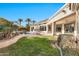 Landscaped backyard oasis with a grassy area and pool at 10410 N 74Th Pl, Scottsdale, AZ 85258