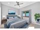 Comfortable bedroom with ceiling fan and large windows at 10410 N 74Th Pl, Scottsdale, AZ 85258