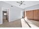 Light-filled bedroom with wood closet doors and tile floors at 10410 N 74Th Pl, Scottsdale, AZ 85258
