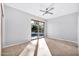 Well-lit bedroom featuring sliding glass doors and tile floors at 10410 N 74Th Pl, Scottsdale, AZ 85258