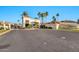 Gated community entrance with palm trees and Spanish-style architecture at 10410 N 74Th Pl, Scottsdale, AZ 85258