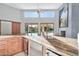 Modern kitchen with granite countertops and wooden cabinets at 10410 N 74Th Pl, Scottsdale, AZ 85258