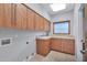 Laundry room with ample wood cabinets and countertop space at 10410 N 74Th Pl, Scottsdale, AZ 85258