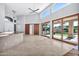 Open living room showcasing tile floors and sliding glass doors at 10410 N 74Th Pl, Scottsdale, AZ 85258