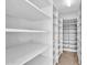 Large walk-in pantry with ample shelving for storage at 10410 N 74Th Pl, Scottsdale, AZ 85258