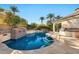 Inviting kidney-shaped pool with a built-in barbecue area at 10410 N 74Th Pl, Scottsdale, AZ 85258