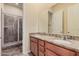 Bathroom with double vanity, granite countertop and tiled shower at 10501 W Swayback Pass, Peoria, AZ 85383