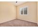 Neutral bedroom with a window providing natural light and ceiling fan overhead at 10501 W Swayback Pass, Peoria, AZ 85383