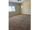 Bedroom with a large window and plush carpeting, creating a cozy and inviting atmosphere at 10501 W Swayback Pass, Peoria, AZ 85383