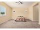 Spacious bedroom featuring large windows, neutral carpet, and ceiling fan at 10501 W Swayback Pass, Peoria, AZ 85383