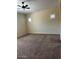 A spacious bedroom with neutral carpeting and two windows, offering a bright and airy feel at 10501 W Swayback Pass, Peoria, AZ 85383