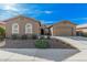 Charming single-story home featuring manicured front yard and a two-car garage at 10501 W Swayback Pass, Peoria, AZ 85383