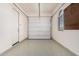 Clean garage featuring durable epoxy flooring and ample space for storage and vehicles at 10501 W Swayback Pass, Peoria, AZ 85383