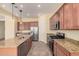 Modern kitchen featuring granite counters and stainless steel appliances at 10501 W Swayback Pass, Peoria, AZ 85383