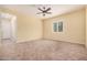 Open living room featuring tile flooring, ceiling fan, and natural light at 10501 W Swayback Pass, Peoria, AZ 85383