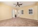Open living room featuring tile flooring, ceiling fan, and natural light at 10501 W Swayback Pass, Peoria, AZ 85383
