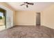 Spacious living room with sliding glass doors, neutral walls, and tile floors at 10501 W Swayback Pass, Peoria, AZ 85383