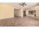 Open-concept living space with tile flooring flowing into the kitchen area at 10501 W Swayback Pass, Peoria, AZ 85383