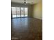 Bright living room featuring large windows and tiled floors, complemented by a modern ceiling fan at 10501 W Swayback Pass, Peoria, AZ 85383