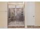 Tile shower with glass door, built-in seat and shelving niche at 10501 W Swayback Pass, Peoria, AZ 85383