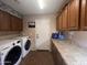 Laundry room with washer, dryer, and ample counter space at 11340 E Stearn Ave, Mesa, AZ 85212