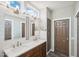 Modern bathroom with dual sinks, white subway tile, and sleek fixtures at 14701 W Sentinel Dr, Sun City West, AZ 85375