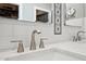 Close up of bathroom double sink with stainless steel fixtures and decorative backsplash at 14701 W Sentinel Dr, Sun City West, AZ 85375