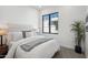 Spacious bedroom with plush bedding, large window, and a plant at 1501 N Miller Rd # 1003, Scottsdale, AZ 85257