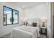 Bright bedroom with a queen bed, large window, and modern decor at 1501 N Miller Rd # 1003, Scottsdale, AZ 85257