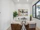 Bright home office features a glass desk and large window at 1501 N Miller Rd # 1003, Scottsdale, AZ 85257