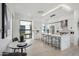 Open concept kitchen with white cabinets, marble island, and breakfast nook at 1501 N Miller Rd # 1003, Scottsdale, AZ 85257