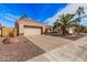 Tan house with tile roof, palm trees, and a landscaped yard at 15112 W Greystone Dr, Sun City West, AZ 85375