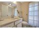 Bathroom with vanity, toilet, and window at 15809 N Bowling Green Dr, Sun City, AZ 85351