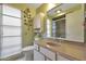 Bathroom with vanity, toilet, shower, and large window at 15809 N Bowling Green Dr, Sun City, AZ 85351