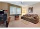 Bedroom with sofa, ceiling fan, and large window at 15809 N Bowling Green Dr, Sun City, AZ 85351